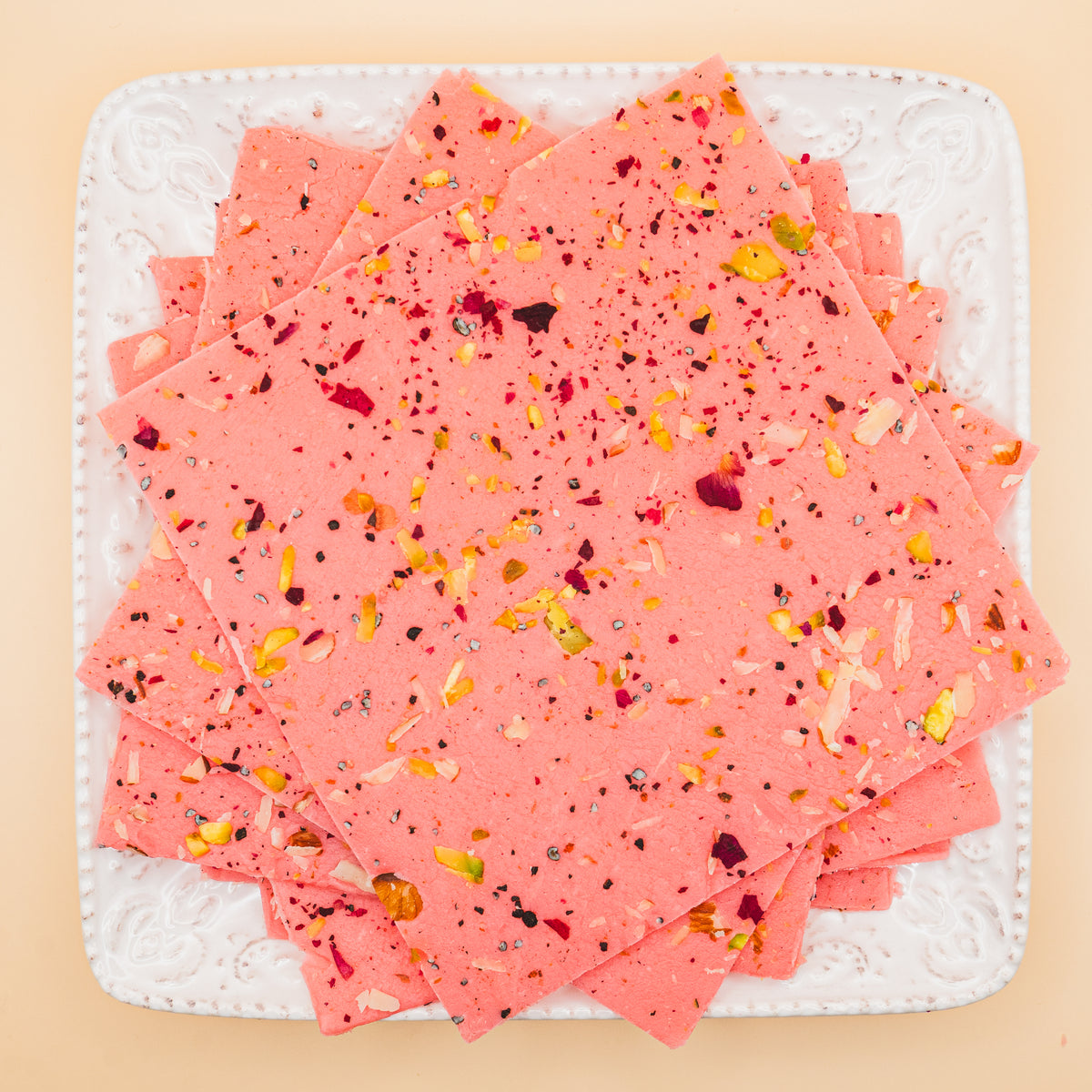 squares of authentic Rose Bombay Ice Halwa garnished with premium nuts, an artisanal Indian mithai by Pavitre.