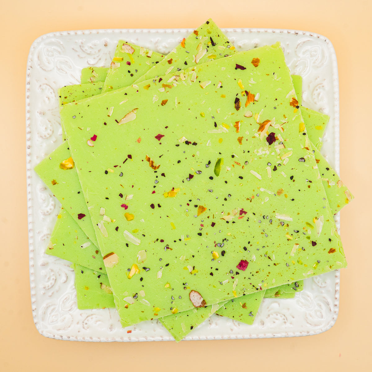 squares of authentic Pistachio Bombay Ice Halwa garnished with premium nuts, an artisanal Indian mithai by Pavitre.