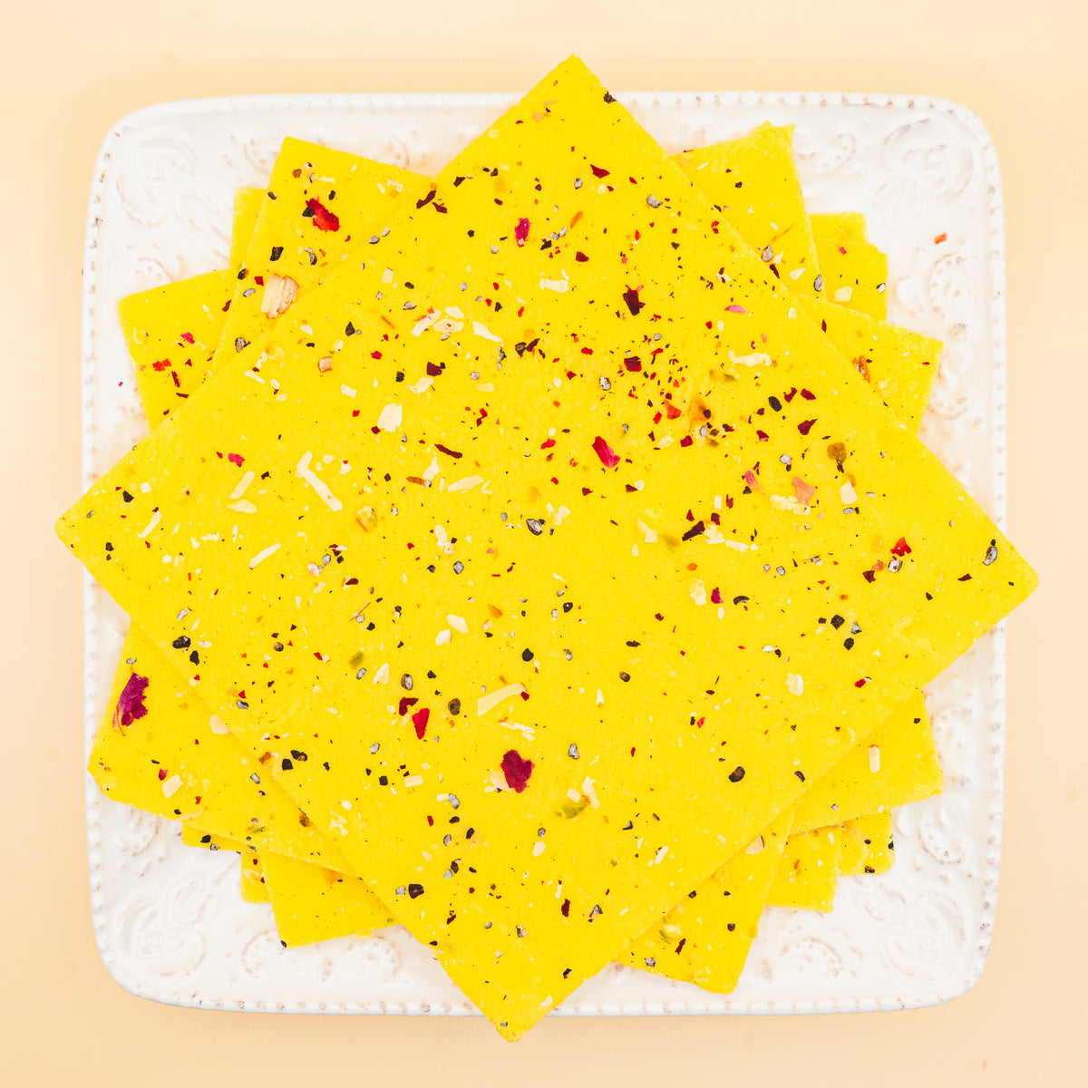 squares of authentic Kesar Bombay Ice Halwa garnished with premium nuts, an artisanal Indian mithai by Pavitre.