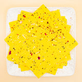 squares of authentic Kesar Bombay Ice Halwa garnished with premium nuts, an artisanal Indian mithai by Pavitre.
