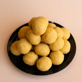Premium Indian sweets for gifting: Besan Ladoo arranged on a festive plate, available for Australia-wide delivery.