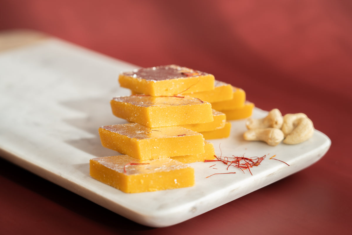 Kesar Kaju Katli sweets made from premium cashews, a pure vegetarian treat with no artificial preservatives.